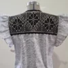 Vestido tela negra jaspeada con bordado negro