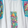 WhatsApp Image 2026-10-14 at 12.51.02 PM Vestido blanco multicolor bordado margaritas ,tejido turquesa