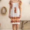 Vestido tela hueso bordado pensamientos tonos rojos y mostazas tejido melón