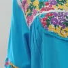 Vestido turquesa bordado colores con holán y bolsas